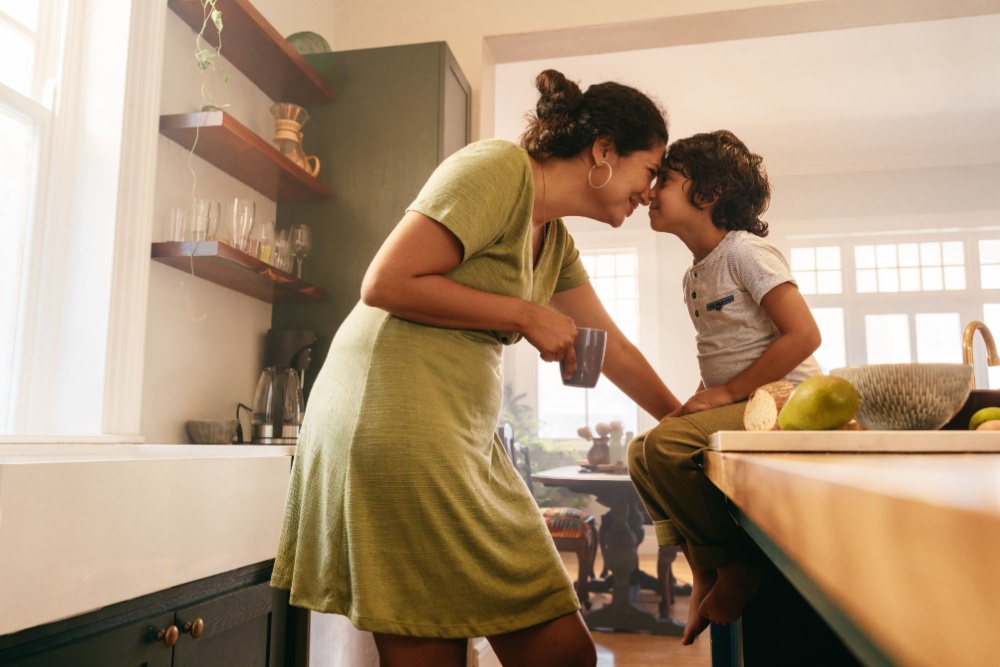 A woman and her child in the kitchen.