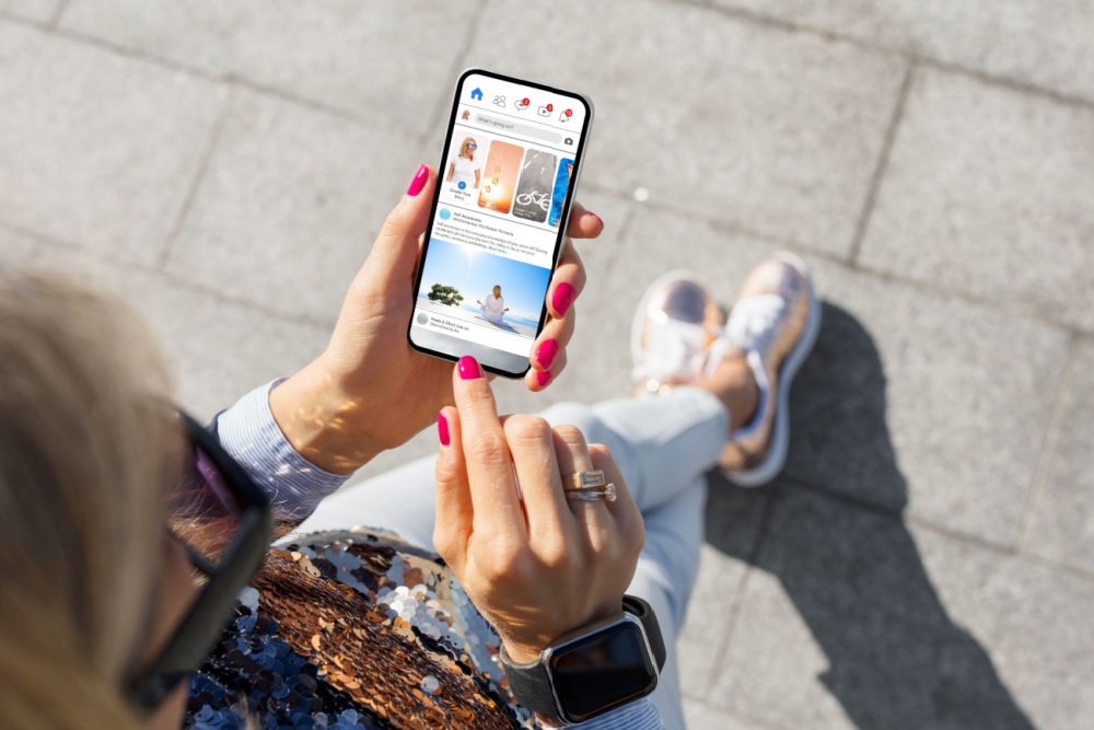 A woman looking at social media on her phone.