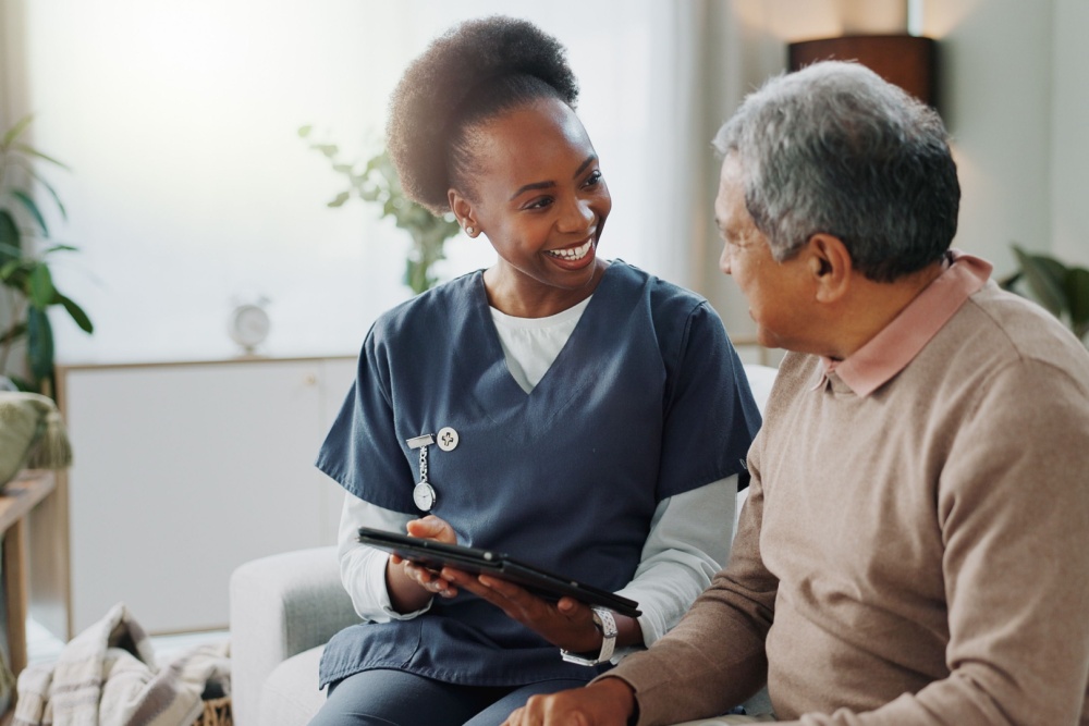 A care worker visiting a man in his home.