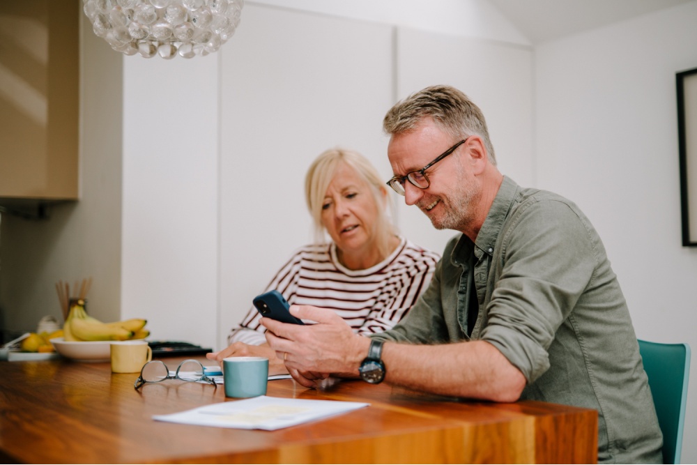 A couple going through paperwork together.