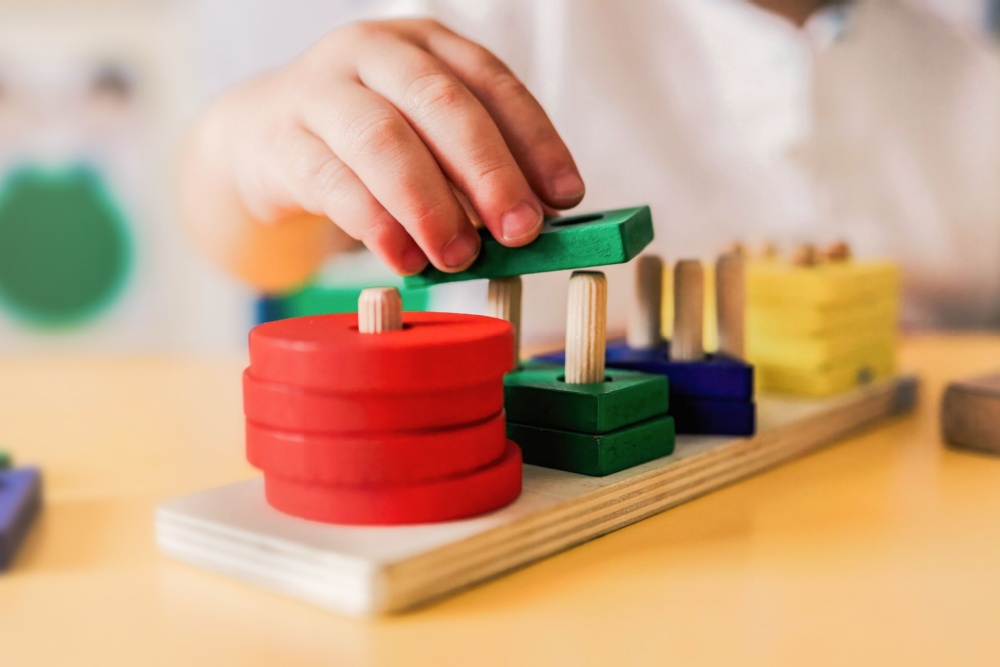 A child playing with wooden shapes.